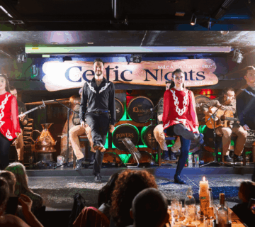 Irish dancers performing on stage at a lively Arlington Hotel bar in Dublin.