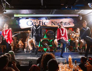 Irish dancers performing on stage at a lively Arlington Hotel bar in Dublin.