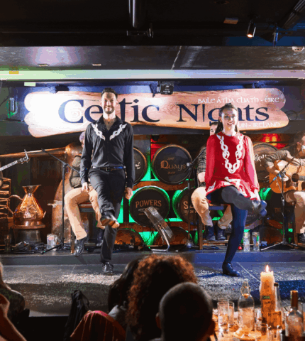 Irish dancers performing on stage at a lively Arlington Hotel bar in Dublin.