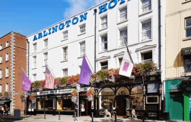 Exterior of Arlington Hotel and Bar in Dublin, vibrant flags and floral displays.