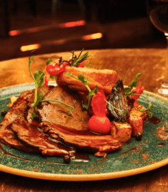 Elegant gourmet dish with wine at Arlington Hotel.