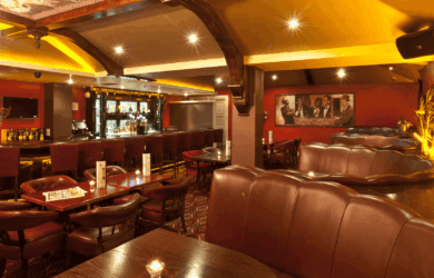 Elegant bar interior with ambient lighting, comfortable seating, and inviting atmosphere.