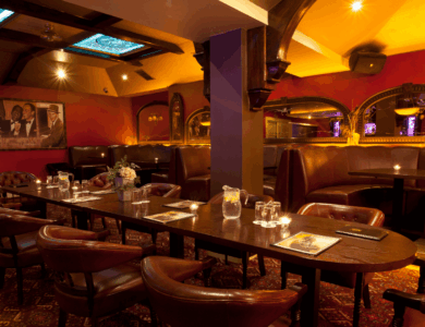 Elegant seating area in Arlington Hotel and Bar, Dublin, with leather chairs and warm lighting.