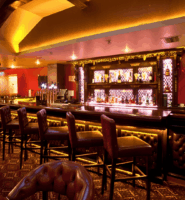 Elegant hotel bar with plush seating and warm lighting, creating a cosy atmosphere for guests.