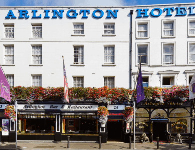 Exterior of Arlington Hotel and Bar in Dublin, adorned with vibrant hanging flowers.