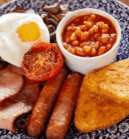 Traditional full English breakfast on a blue floral plate.