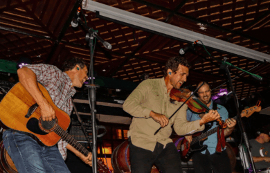 Energetic band performing live in a cosy bar setting.