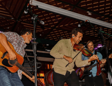 Energetic band performing live in a cosy bar setting.