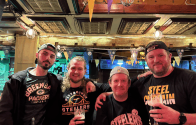 Four friends enjoying drinks in a cosy, inviting pub setting.