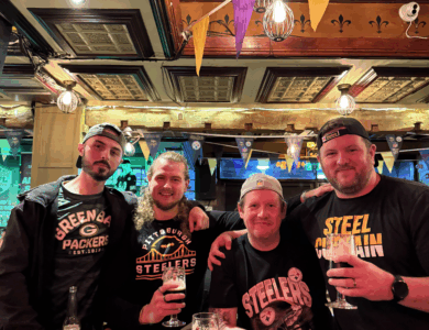 Four friends enjoying drinks in a cosy, inviting pub setting.