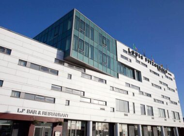 Modern exterior of Louis Fitzgerald Hotel with bar entrance.