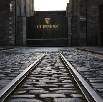Cobblestone street leading to Guinness brewery entrance in Dublin.