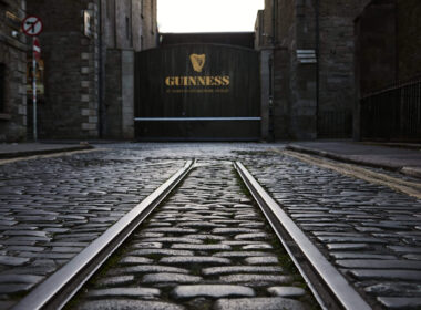 Cobblestone street leading to Guinness brewery entrance in Dublin.