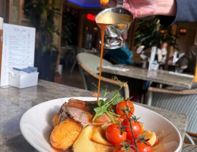 Luxurious roast dinner being served in a cosy Arlington Hotel bar setting.