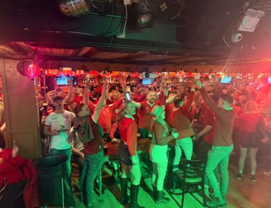 Guests joyfully celebrating in a lively bar atmosphere.