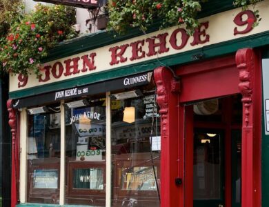 Historic pub with flower-adorned exterior and classic signage in Dublin.