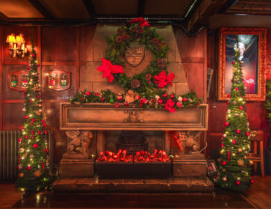 Cosy hotel lobby with festive decorations and Christmas trees, inviting warmth.