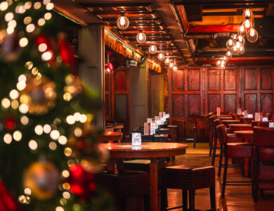Warm, inviting hotel bar with festive decorations and intimate seating arrangements.